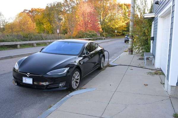 Electric vehicle charging outside a home